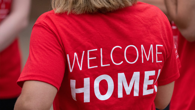 Back of WUSAs shirt that says "Welcome Home"